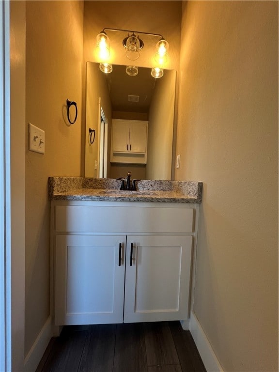 bathroom featuring vanity and hardwood / wood-style floors