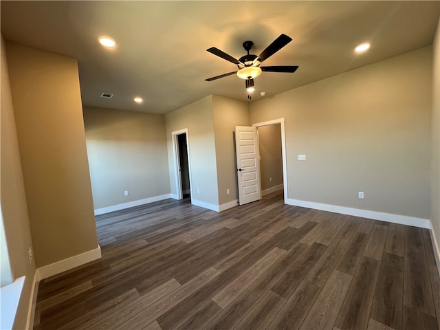 spare room with ceiling fan and dark hardwood / wood-style flooring