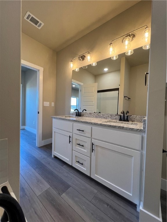 bathroom featuring double sink vanity and hardwood / wood-style flooring