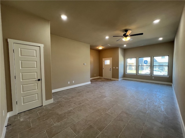 tiled empty room featuring ceiling fan