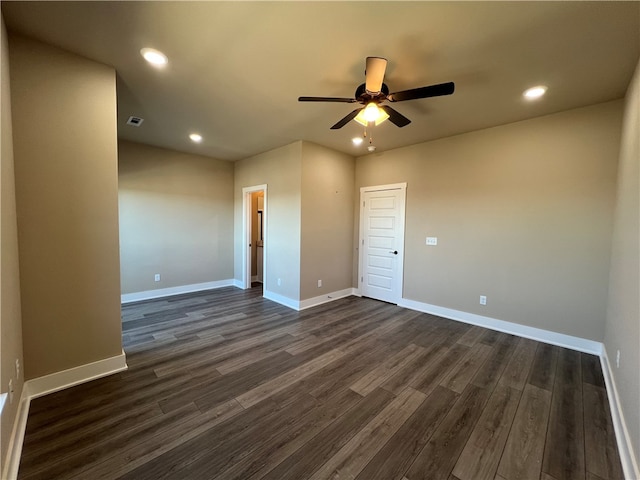 empty room with dark hardwood / wood-style flooring and ceiling fan