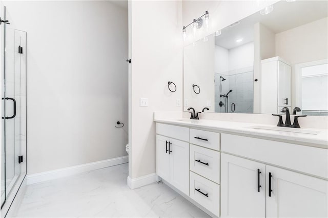 bathroom with toilet, a shower with door, and vanity