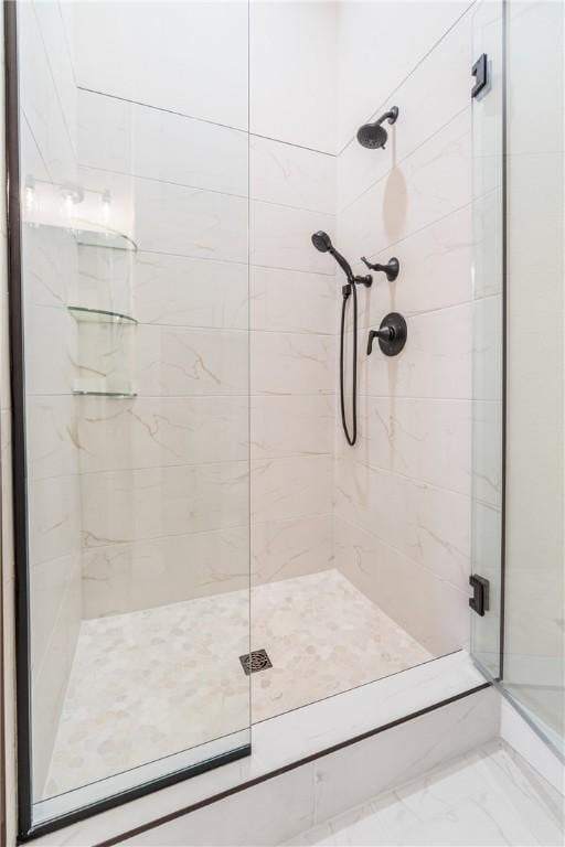 bathroom with a shower with shower door