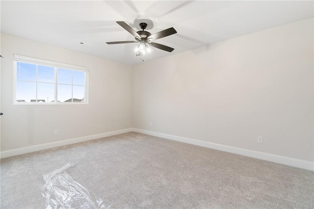 unfurnished room featuring ceiling fan and light carpet