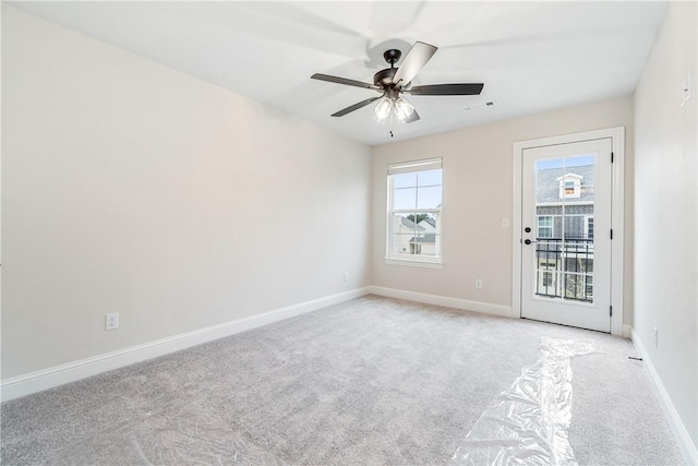 unfurnished room with ceiling fan and light colored carpet