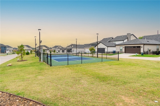 view of sport court featuring a yard