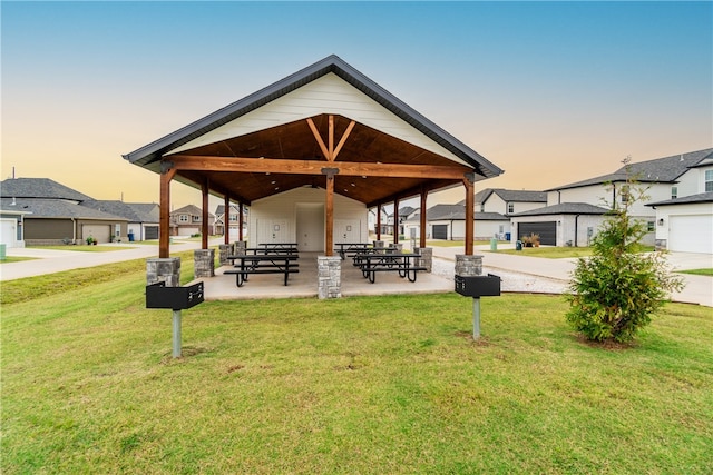 view of community featuring a patio and a lawn