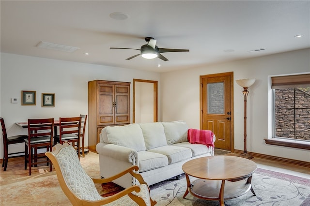 living room with ceiling fan and light hardwood / wood-style flooring