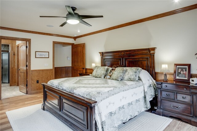 bedroom with ceiling fan, crown molding, and light hardwood / wood-style floors