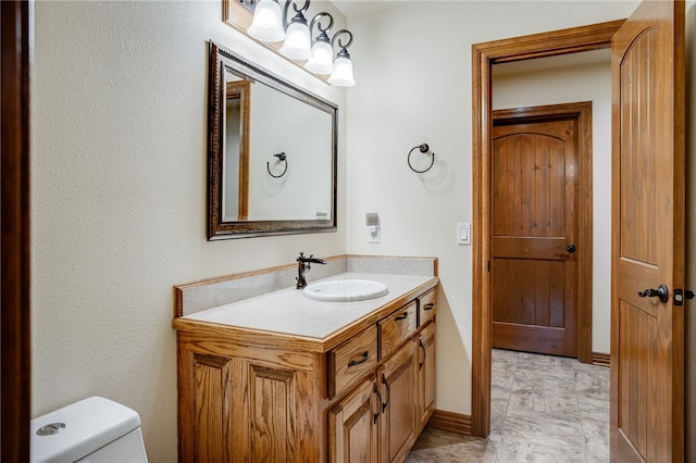 bathroom with tile floors, toilet, and vanity