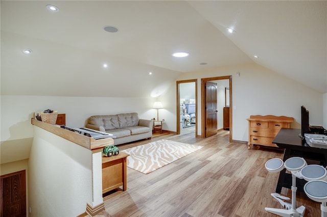 living room with lofted ceiling and light hardwood / wood-style floors