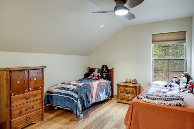 bedroom with light hardwood / wood-style flooring, ceiling fan, and vaulted ceiling