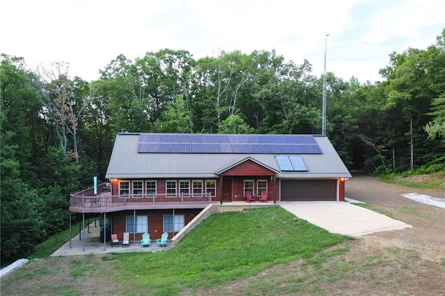 view of front of home featuring a front lawn and solar panels