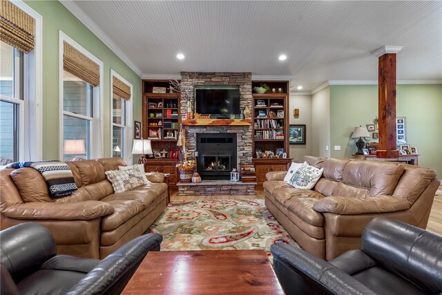 living room with built in shelves, crown molding, a fireplace, and hardwood / wood-style flooring