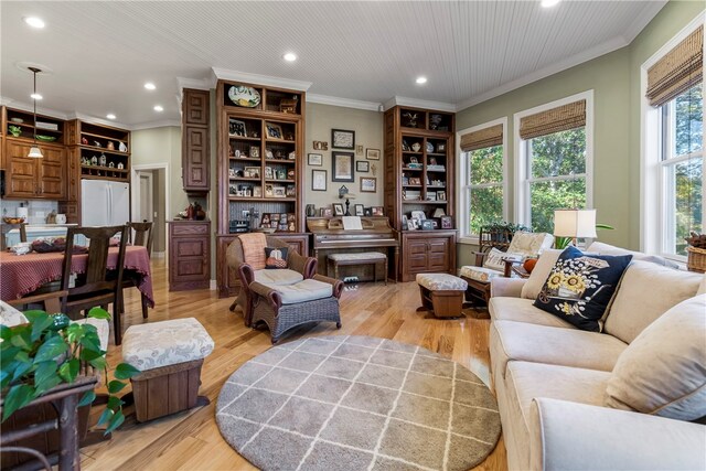 living room featuring light wood-type flooring and crown molding