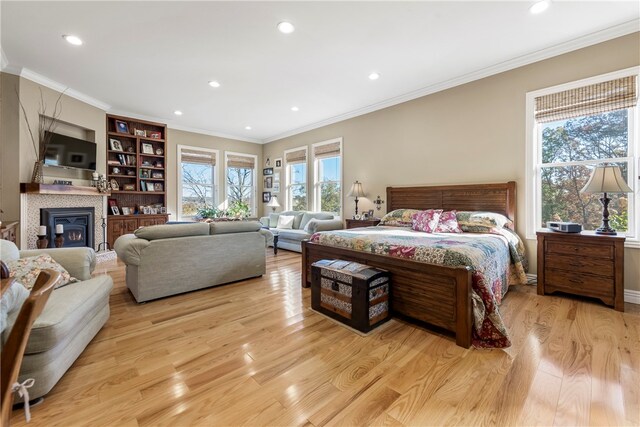 bedroom with light wood-type flooring and ornamental molding