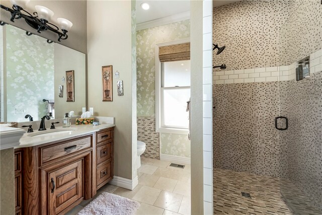 bathroom with vanity, tile patterned flooring, toilet, ornamental molding, and an enclosed shower