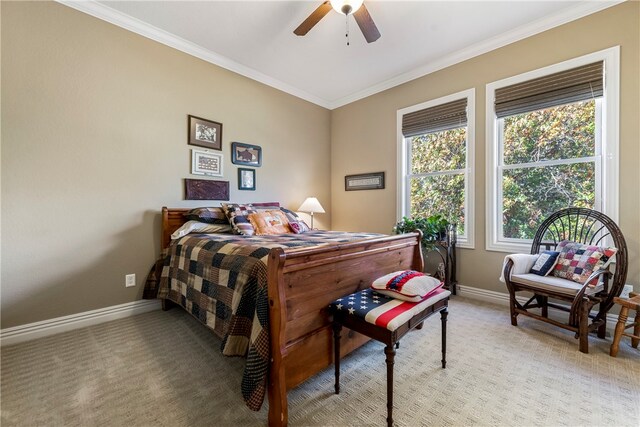 carpeted bedroom featuring ceiling fan and ornamental molding