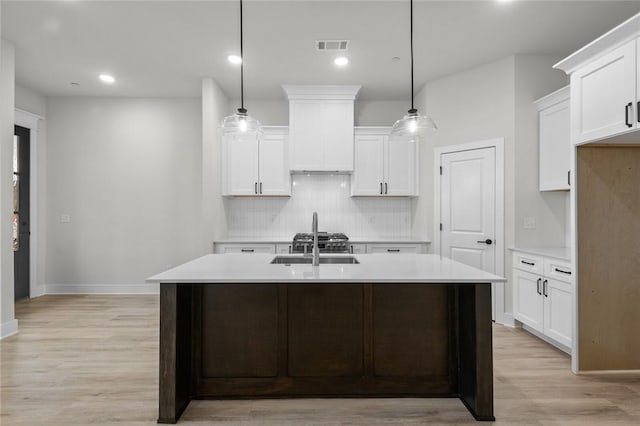 3058 W Berkeley Ave, Rogers, AR 72758 - kitchen featuring light wood-type flooring, light countertops, decorative backsplash, white cabinetry, and recessed lighting