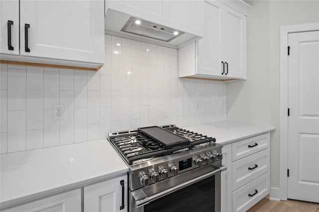 3058 W Berkeley Ave, Rogers, AR 72758 - kitchen featuring high end stainless steel range, extractor fan, light countertops, decorative backsplash, and white cabinets