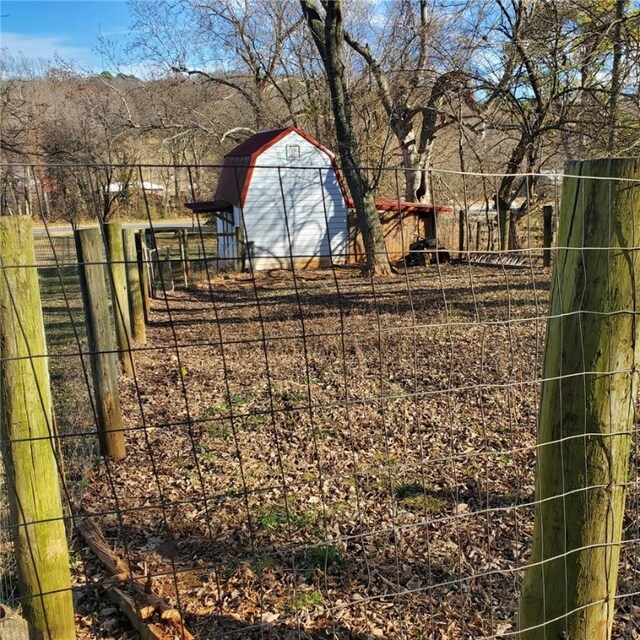 view of yard with an outbuilding and fence