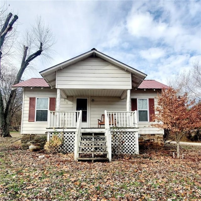 view of front facade with covered porch and metal roof