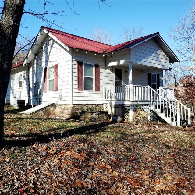 bungalow-style house with covered porch and metal roof