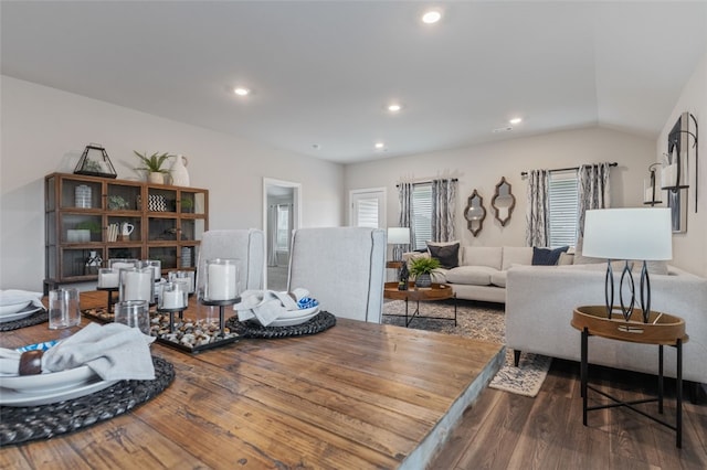 living room featuring wood-type flooring and lofted ceiling