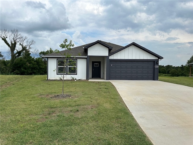 view of front of home featuring a garage and a front lawn