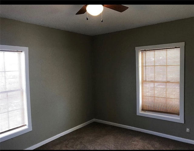 unfurnished room with carpet flooring, ceiling fan, and baseboards