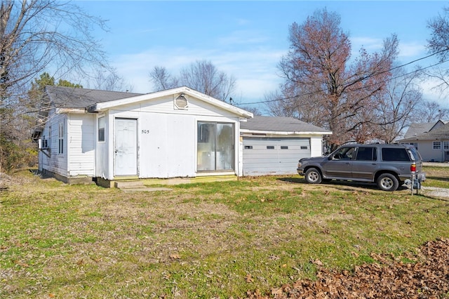 exterior space with a garage and a front lawn