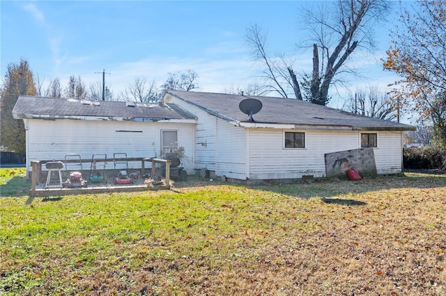 back of property featuring a yard