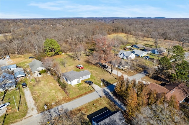 birds eye view of property featuring a residential view and a wooded view