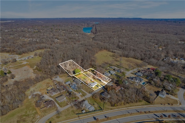 birds eye view of property with a wooded view