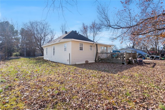 back of house featuring a wooden deck