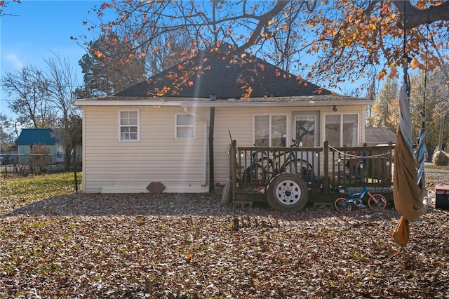 rear view of property featuring a sunroom