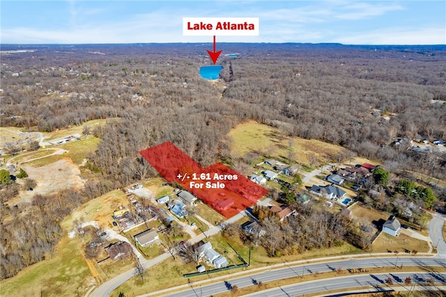 birds eye view of property with a forest view