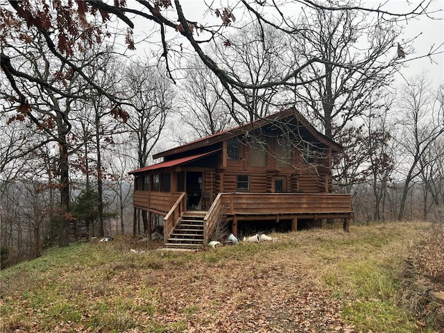 back of house with a deck