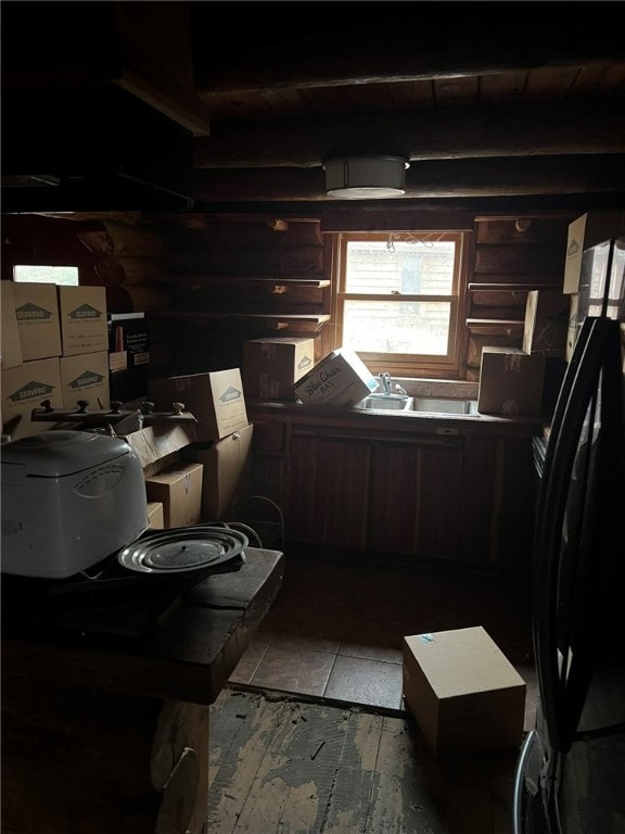 kitchen with dark brown cabinets and black refrigerator