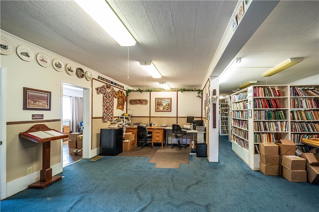 home office featuring dark carpet and a textured ceiling