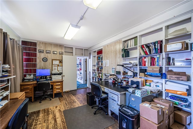 home office with wood walls and dark hardwood / wood-style flooring