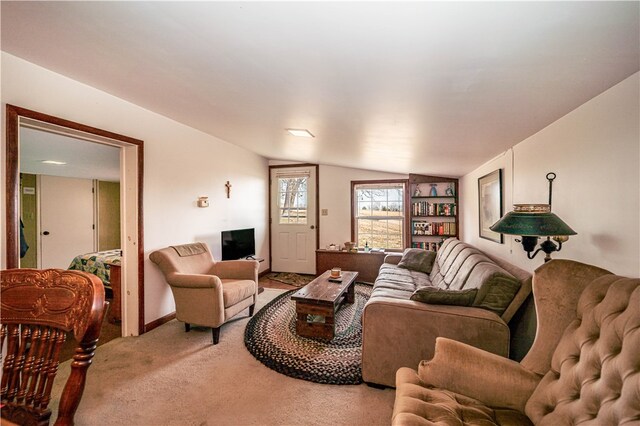 carpeted living room featuring lofted ceiling