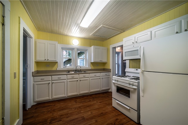 kitchen featuring white appliances, white cabinetry, dark hardwood / wood-style flooring, and sink