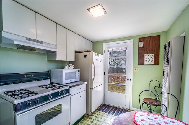 kitchen with white cabinets and white appliances