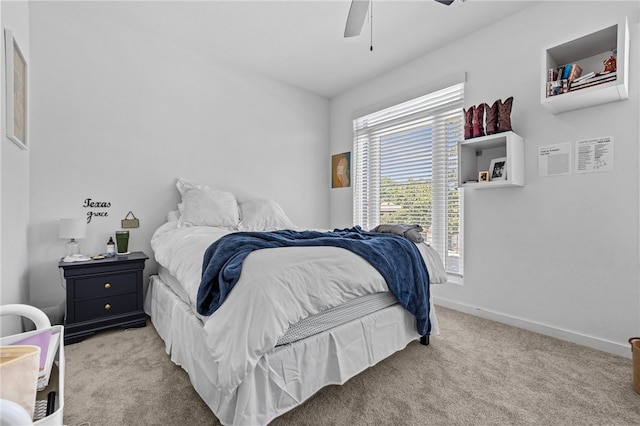 bedroom featuring light colored carpet and ceiling fan