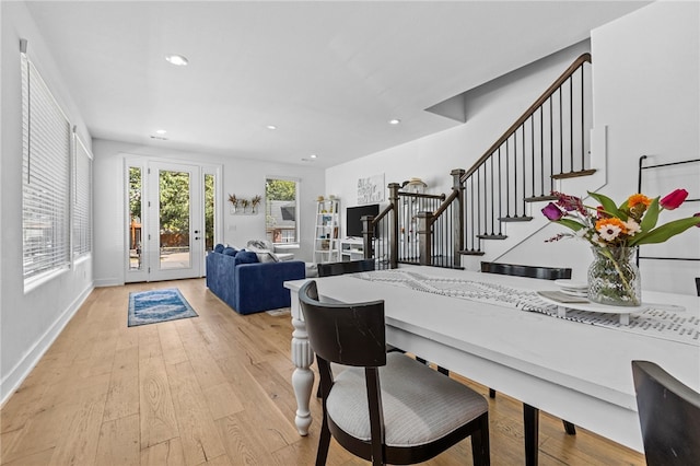 dining room with french doors and light hardwood / wood-style floors