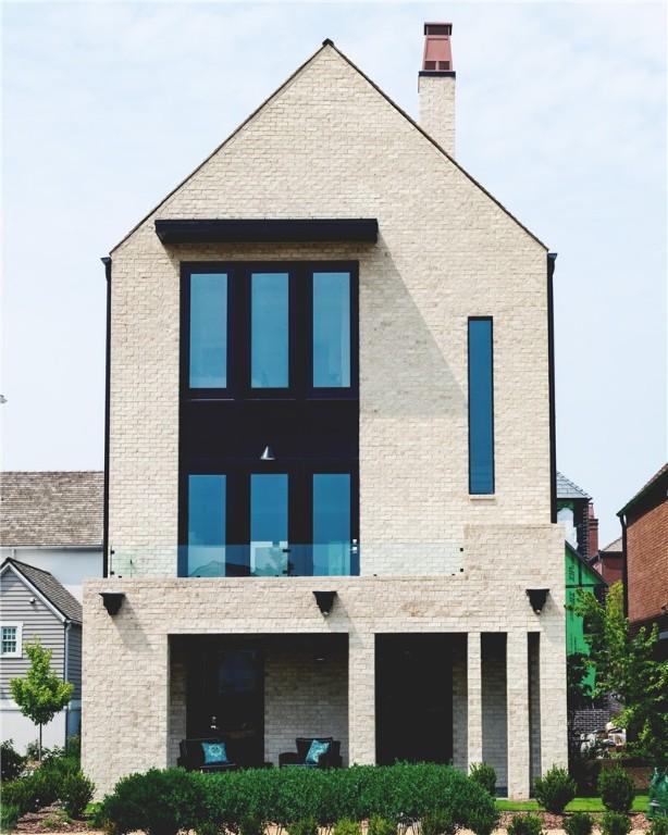 exterior space featuring brick siding and a chimney