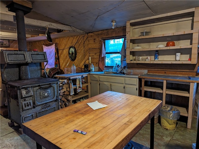 kitchen featuring wood walls and a wood stove