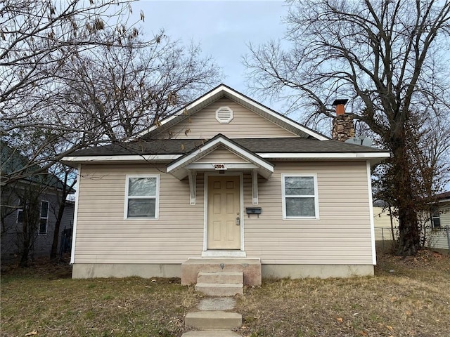 bungalow-style home featuring a front yard