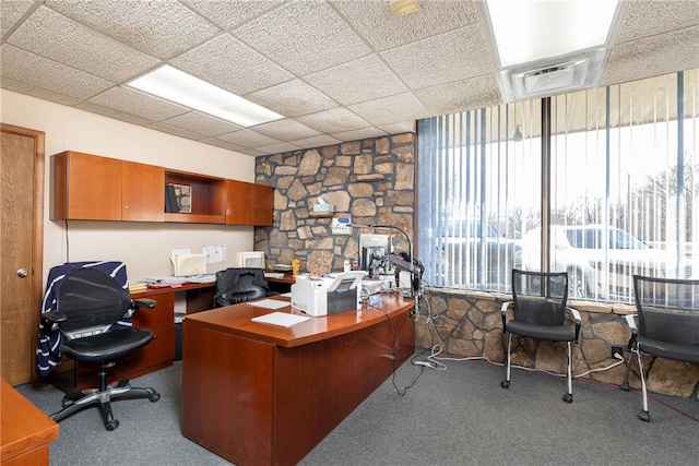 office space with a paneled ceiling and carpet flooring